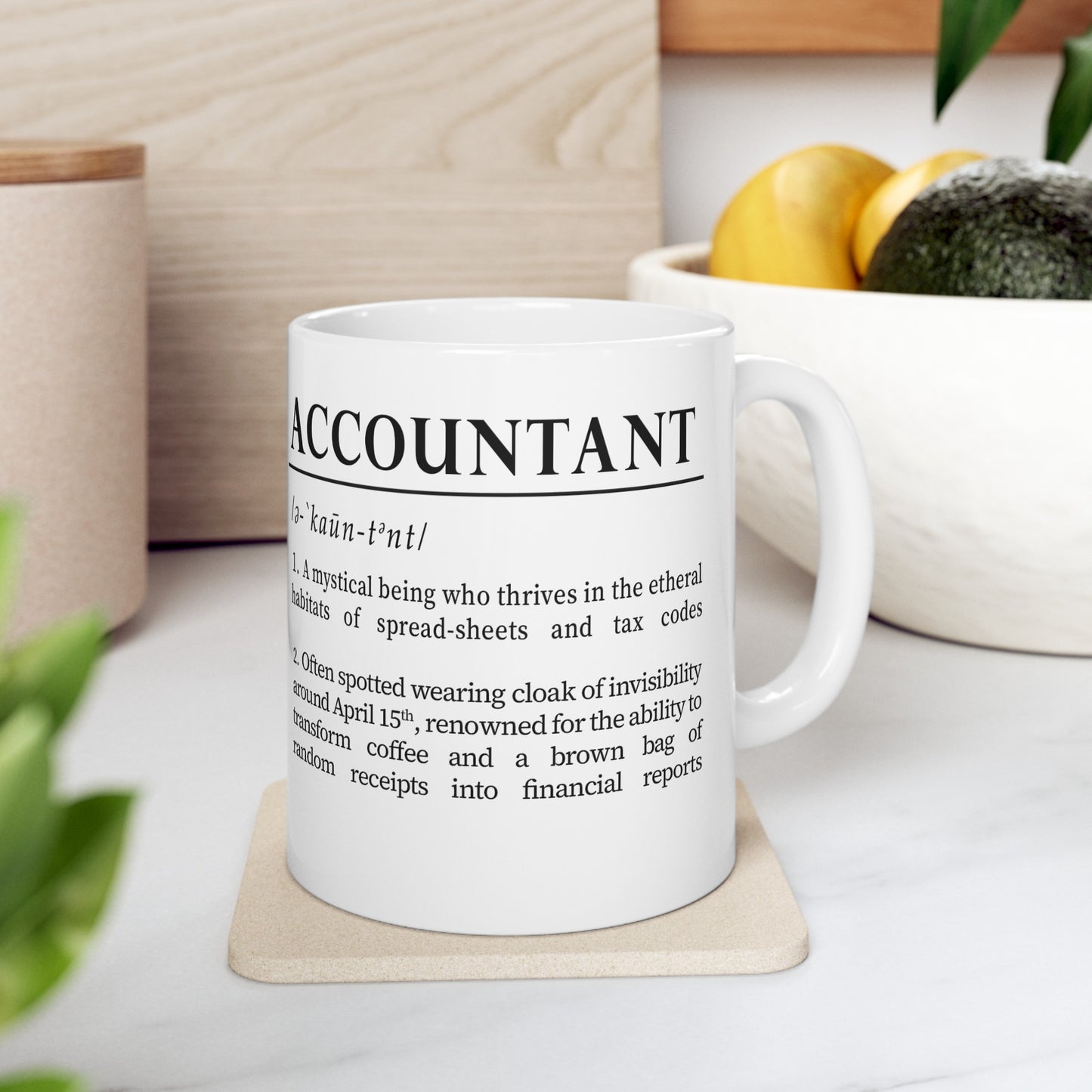 A sleek white ceramic mug presents a whimsical definition of 'accountant', written in bold black font