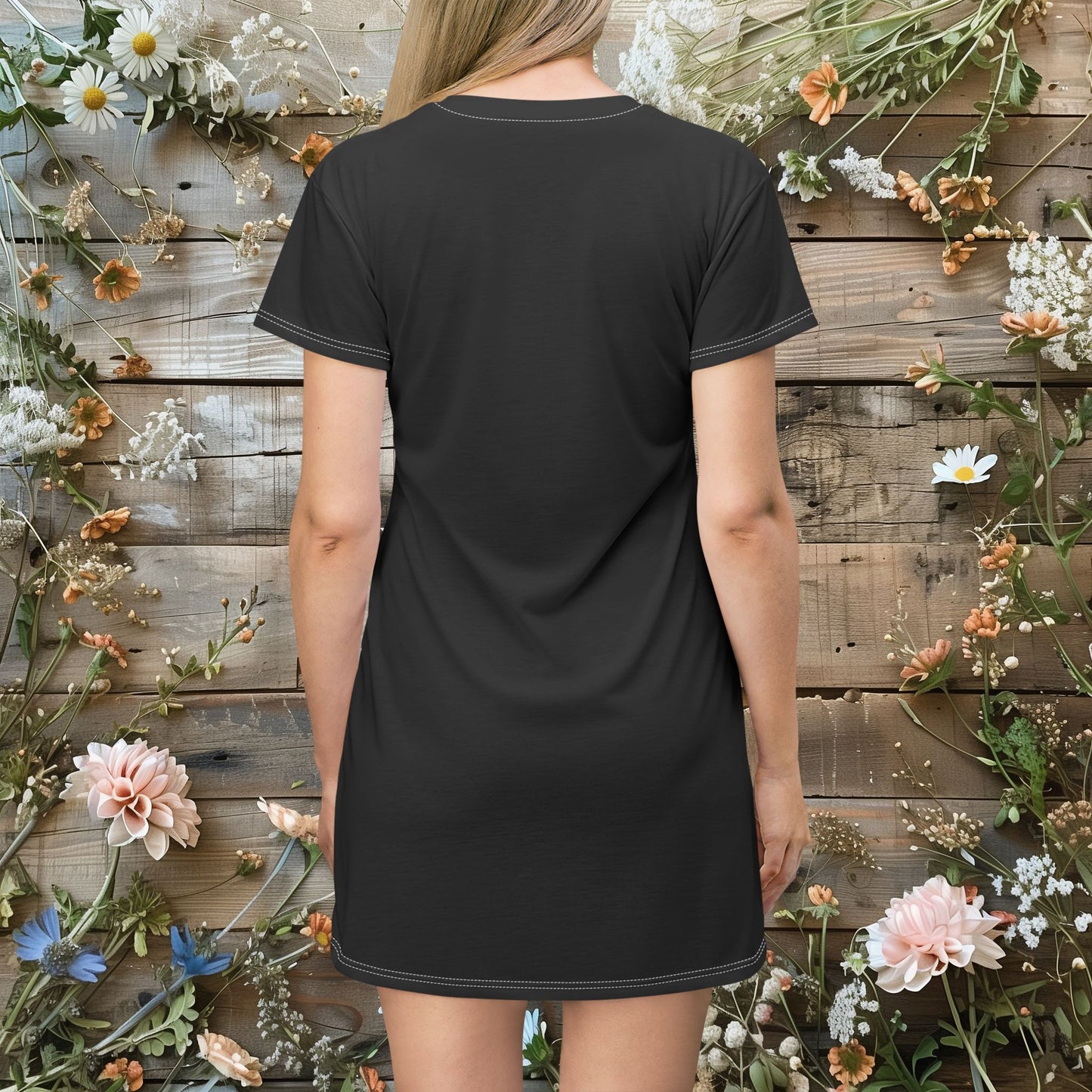 a woman standing in front of a wooden wall and wearing a t-shirt dress