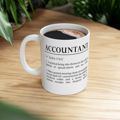 A sleek white ceramic mug presents a whimsical definition of 'accountant', written in bold black font