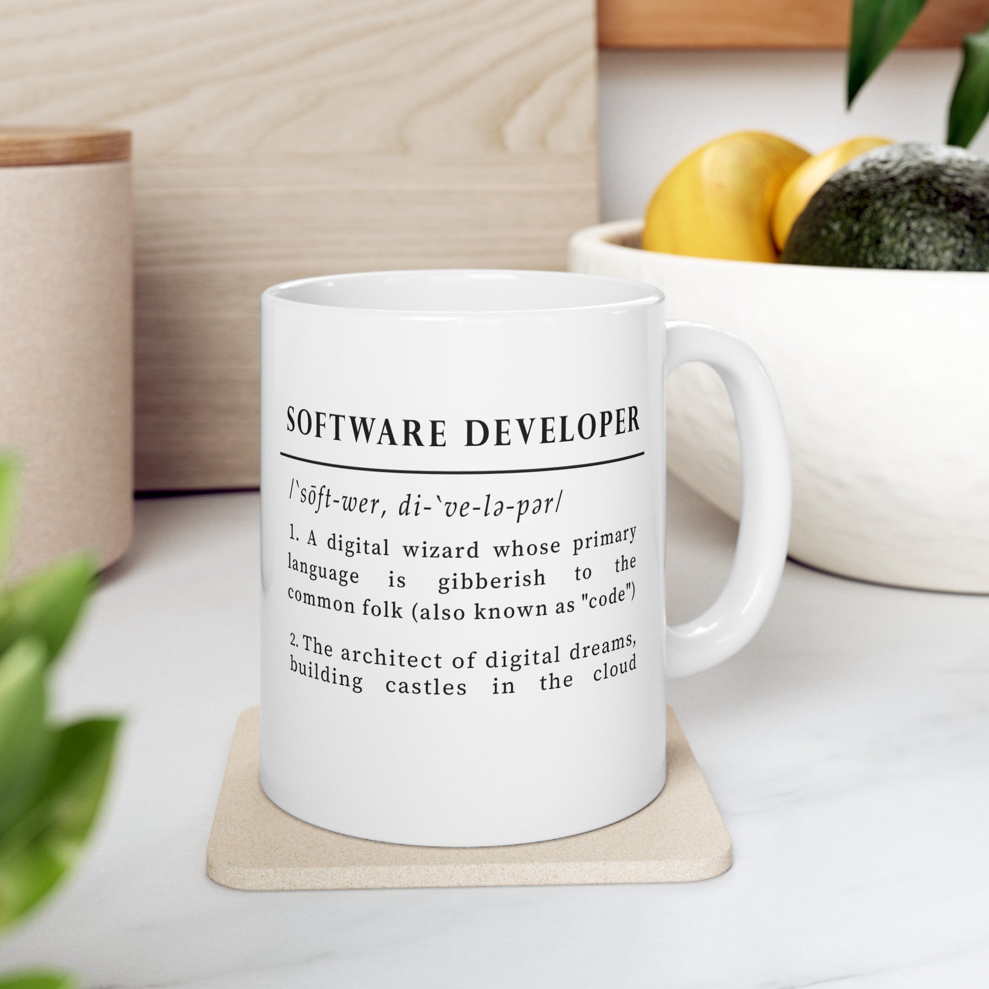 The image showcases a white ceramic mug with a whimsical definition of 'Software Developer' printed in black. The text highlights the developer as a digital wizard and an architect of digital dreams, using a clever tone to describe coding as a mysterious language.