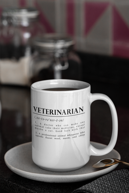 a white cup with bold black text on a plain white background defining 'Veterinarian'. The definition humorously mentions a vet's challenges with medicating animals, especially cats, and describes them as fluent in animal sounds.