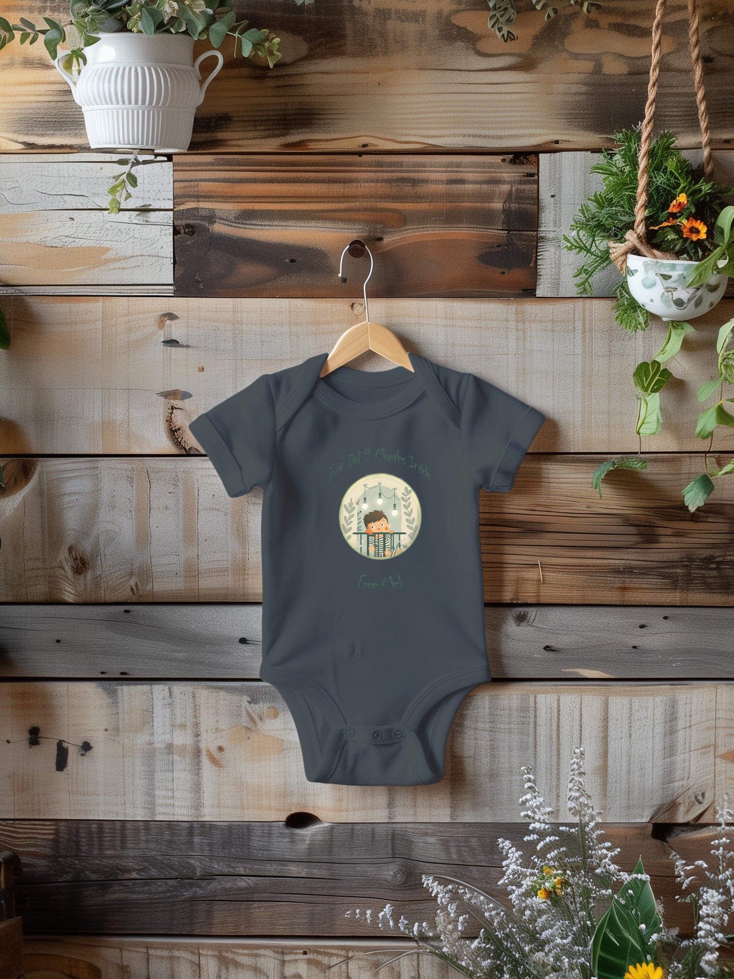 a baby bodysuit hanging on a wooden wall