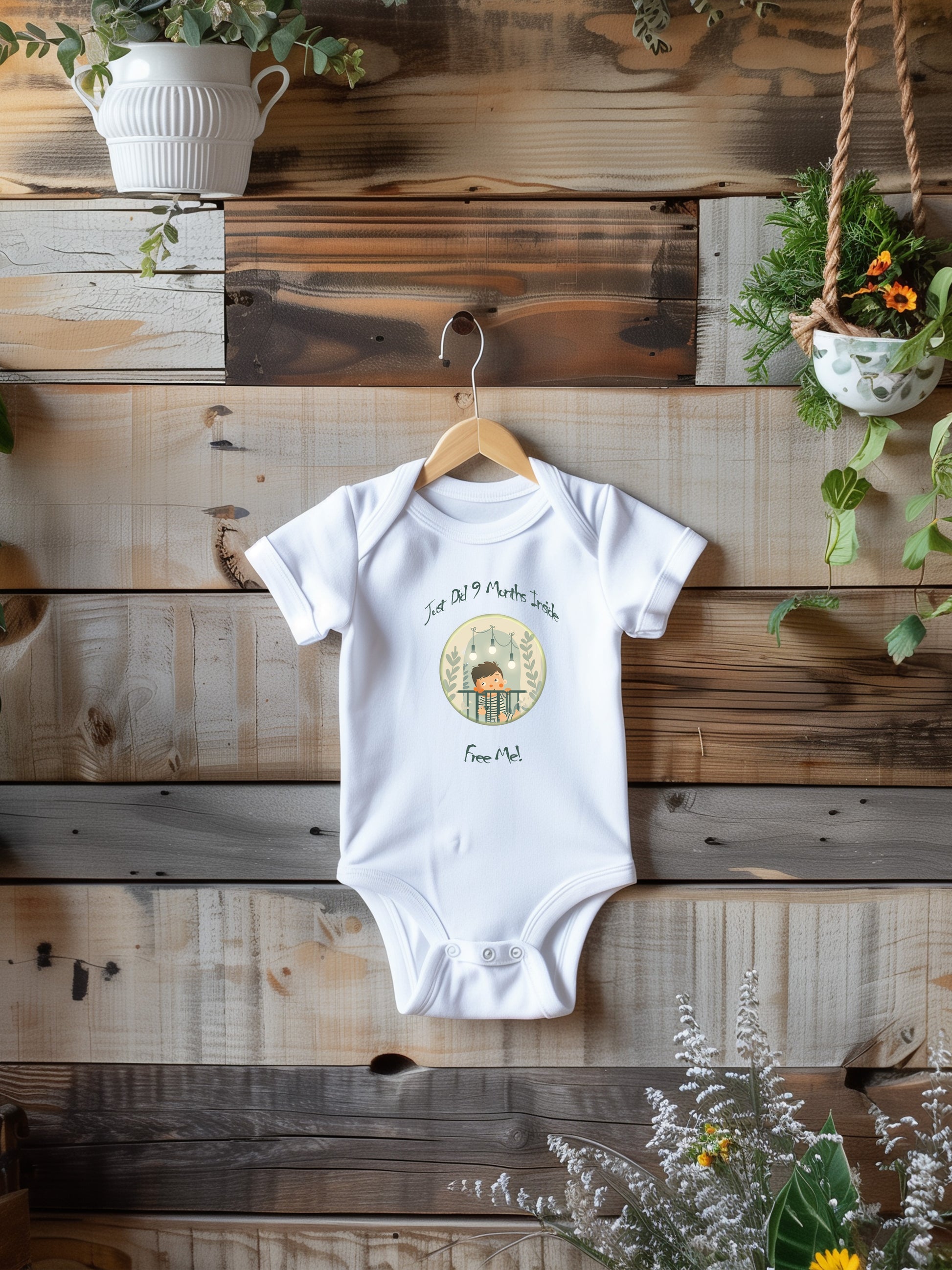 a baby bodysuit hanging on a wooden wall