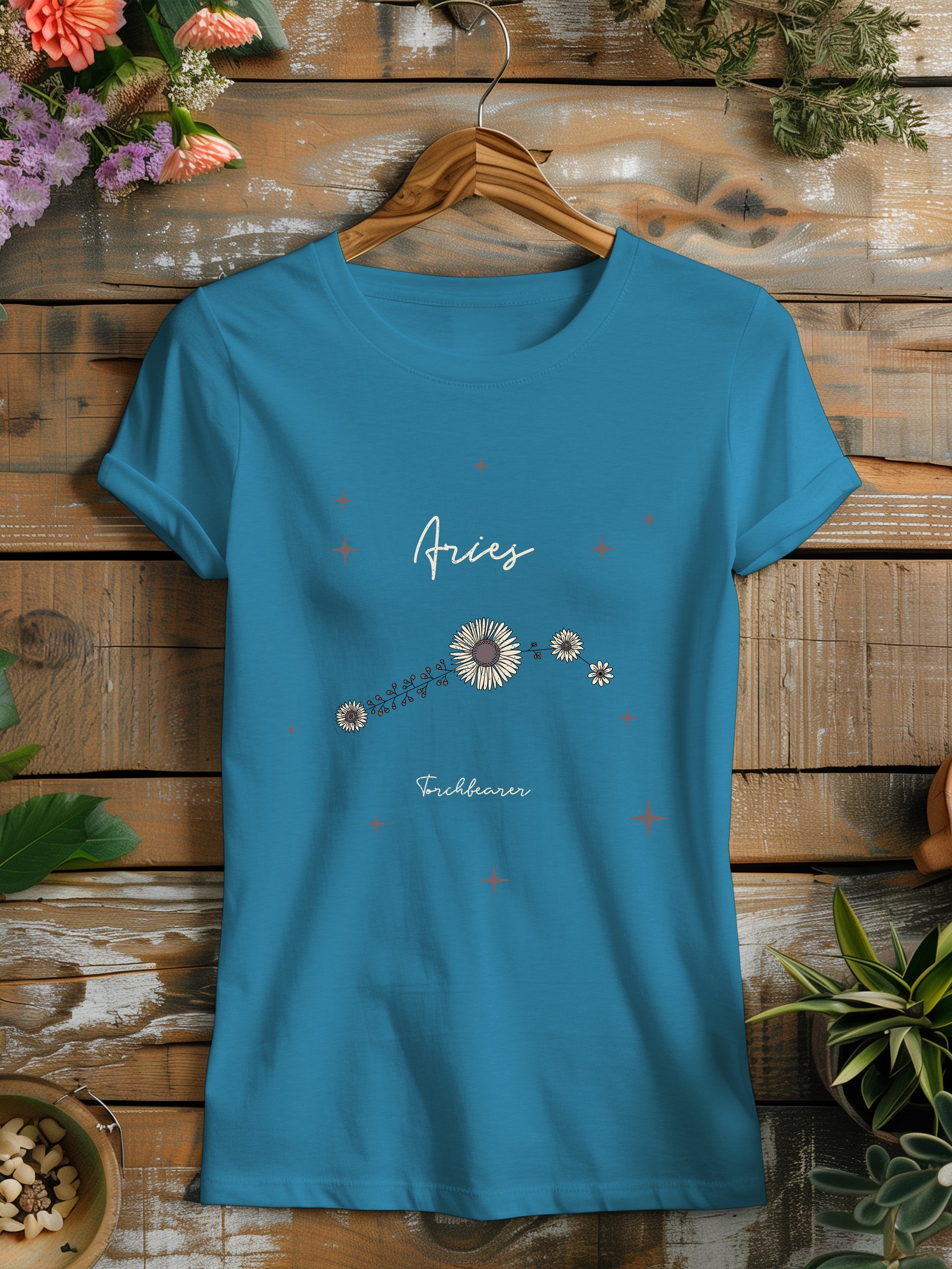 a blue t - shirt with a flower design on it