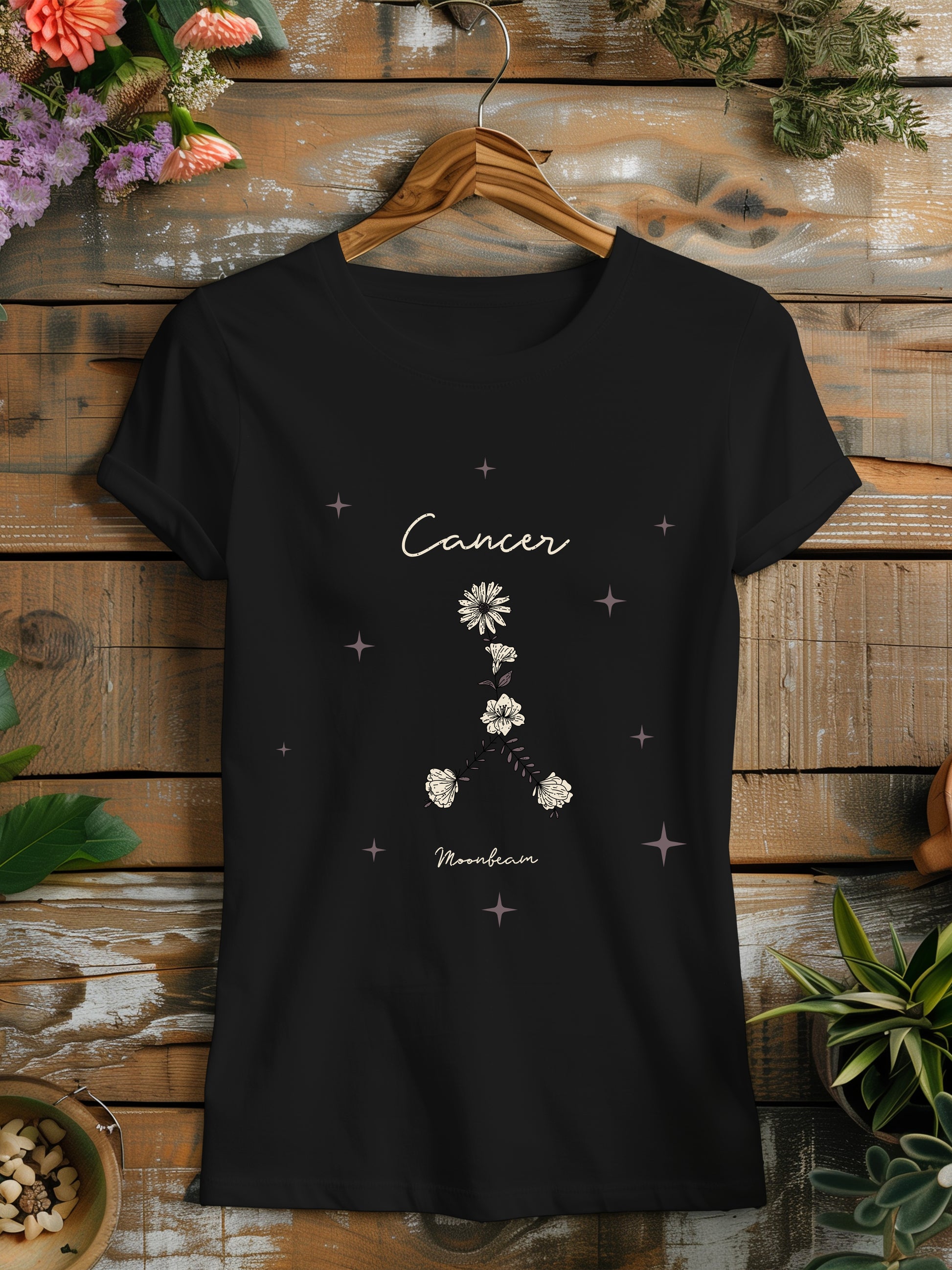 a black t - shirt with a flower design on it