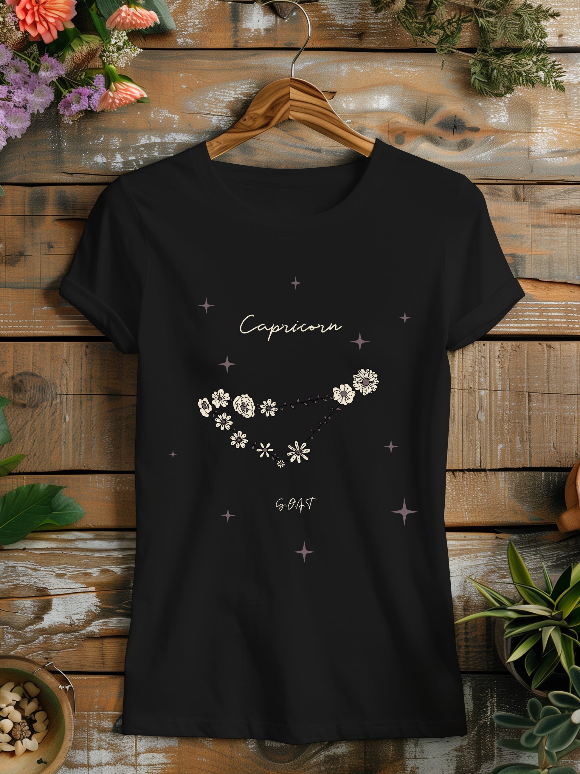 a black t - shirt with white flowers on it