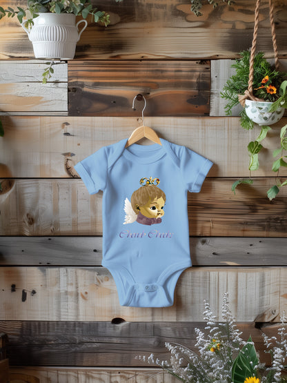 a baby bodysuit hanging on a wooden wall