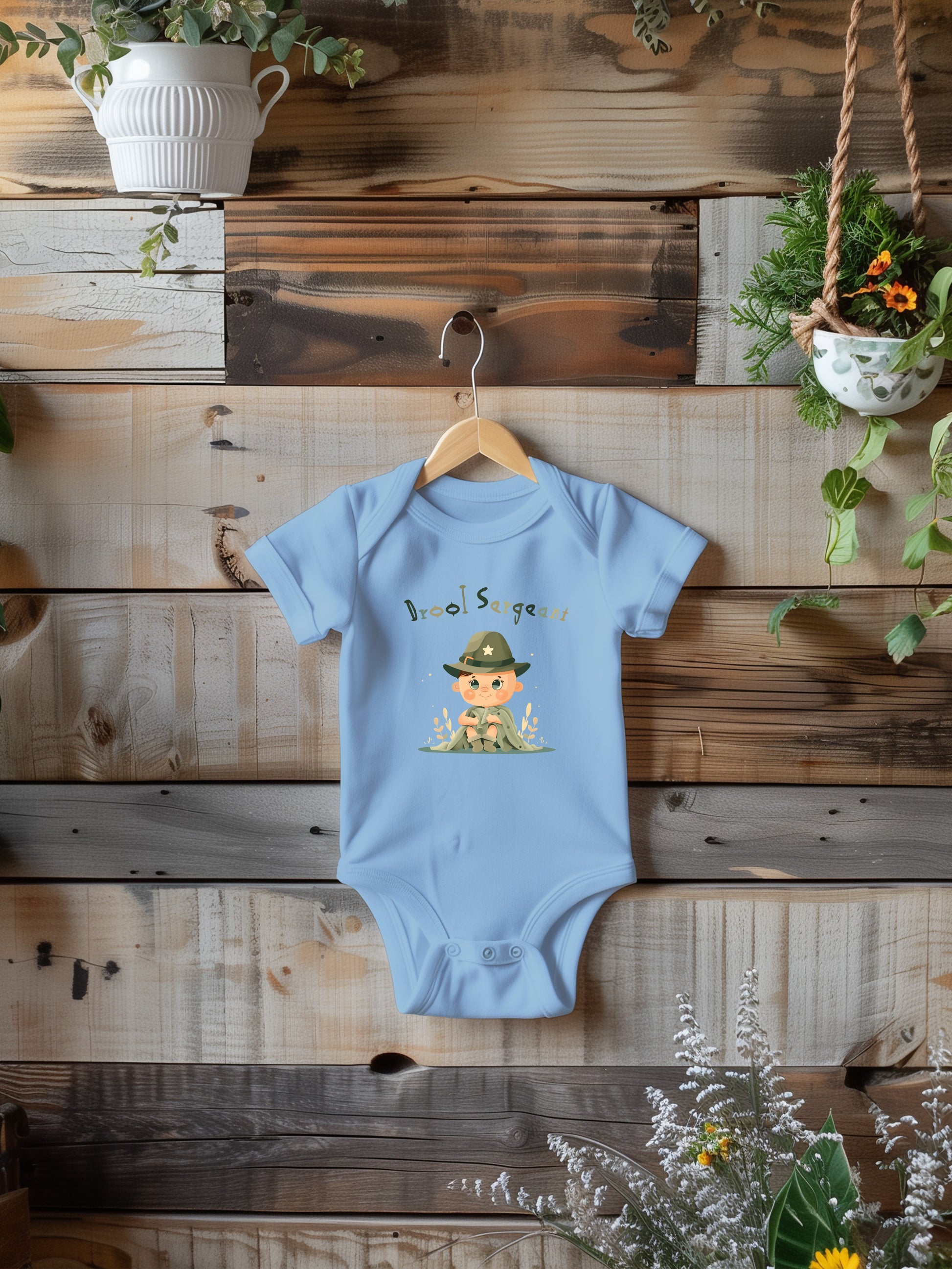 a baby bodysuit hanging on a wooden wall