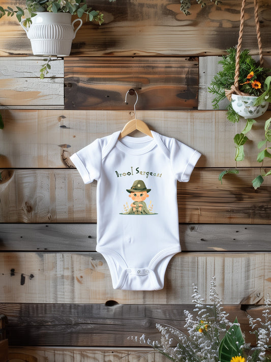 a baby bodysuit hanging on a wooden wall