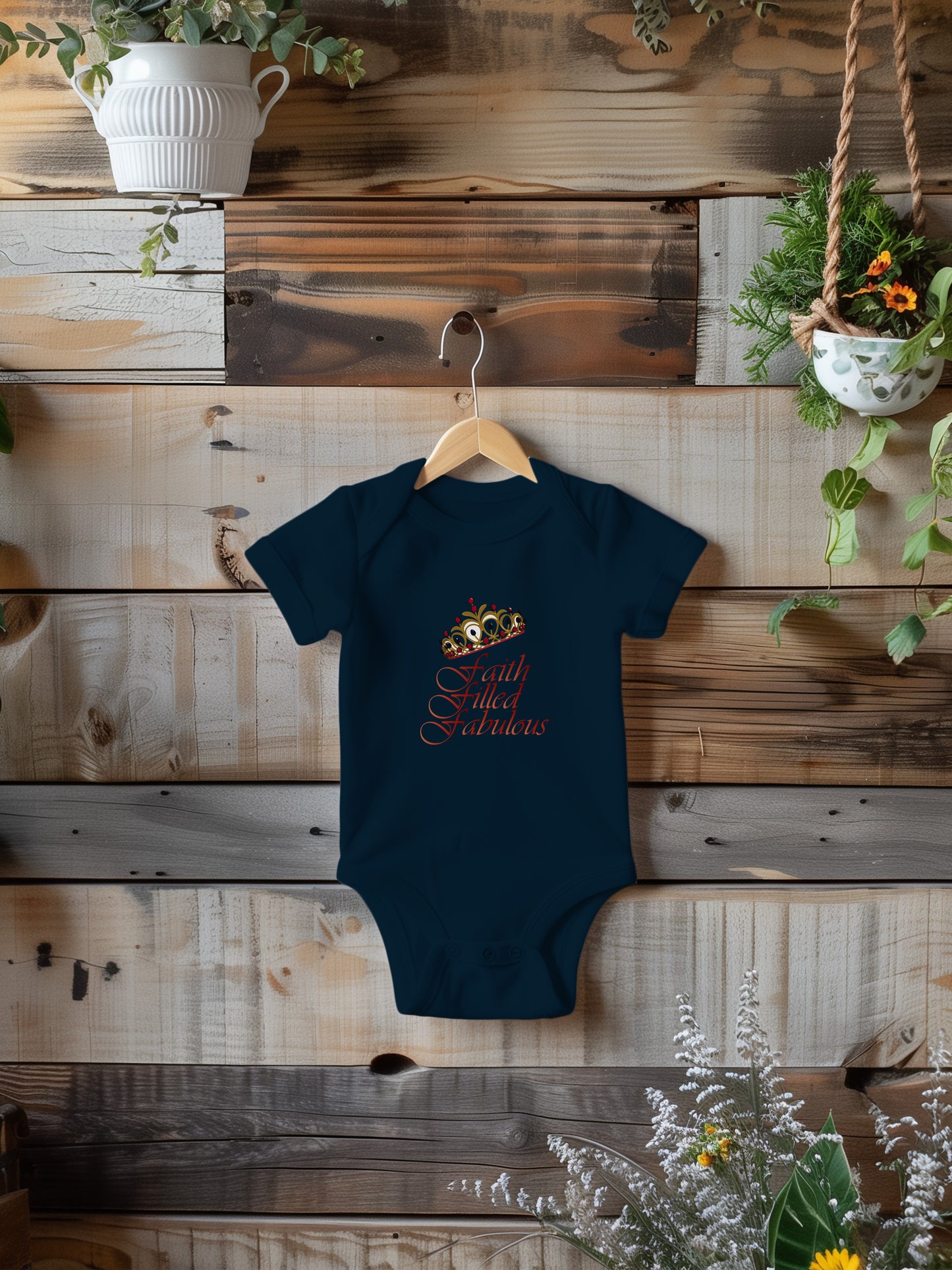 a baby bodysuit hanging on a wooden wall