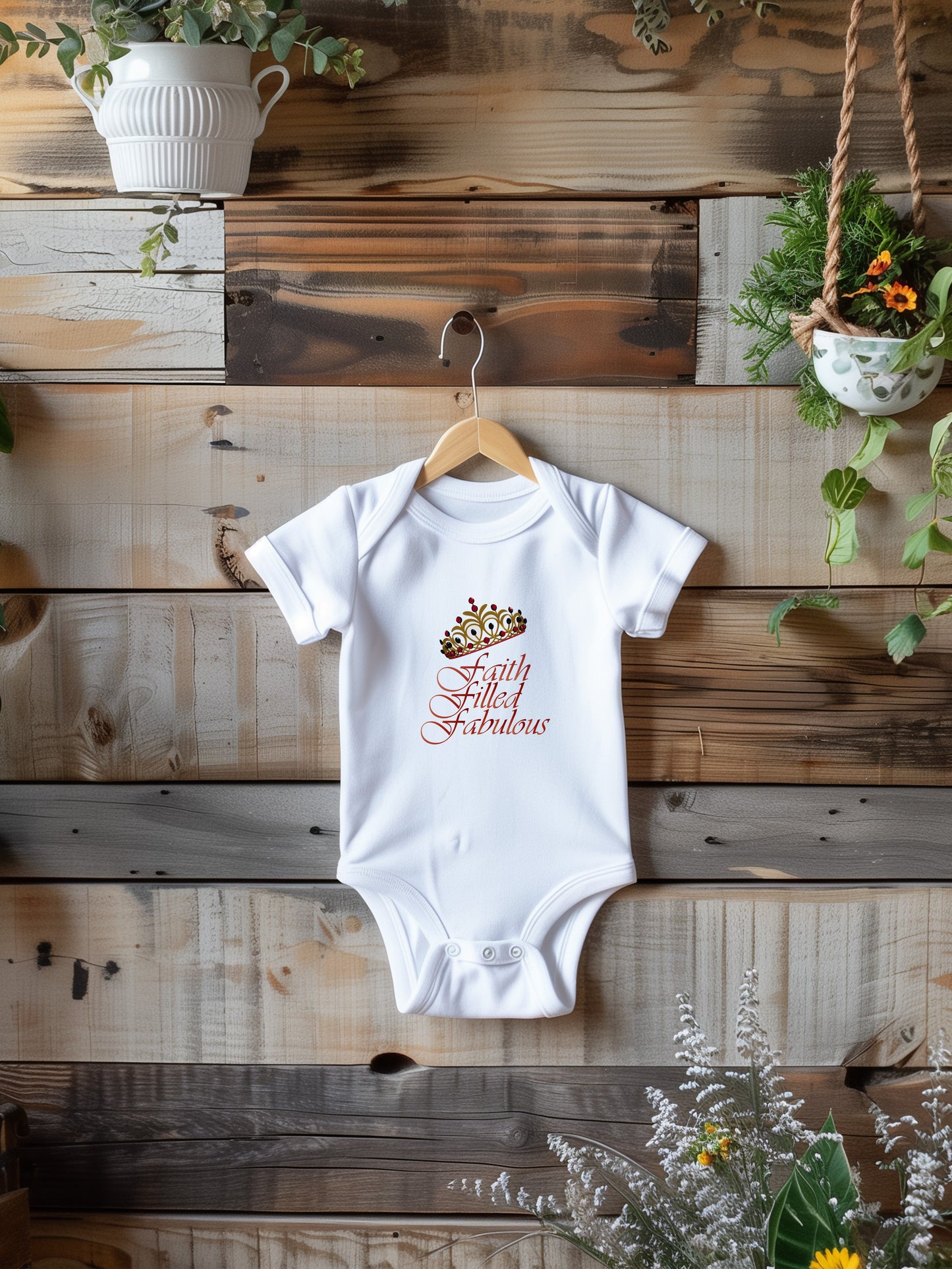 a baby bodysuit hanging on a wooden wall