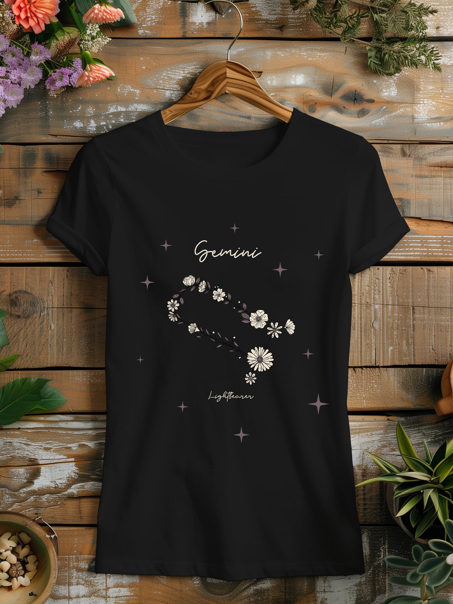 a black t - shirt with a flower design on it