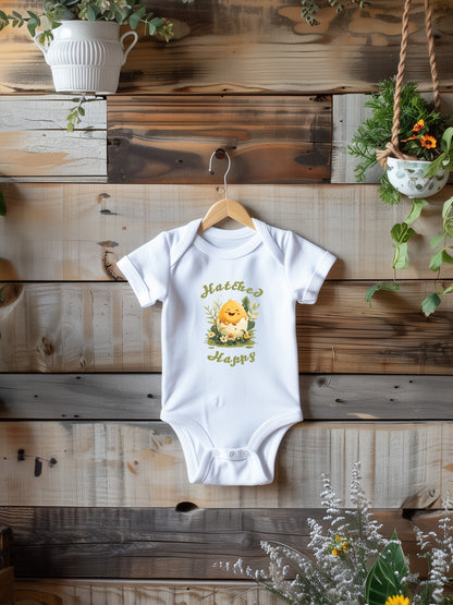 Baby Onesie with a smiling chick in an egg shell with text hatched happy.