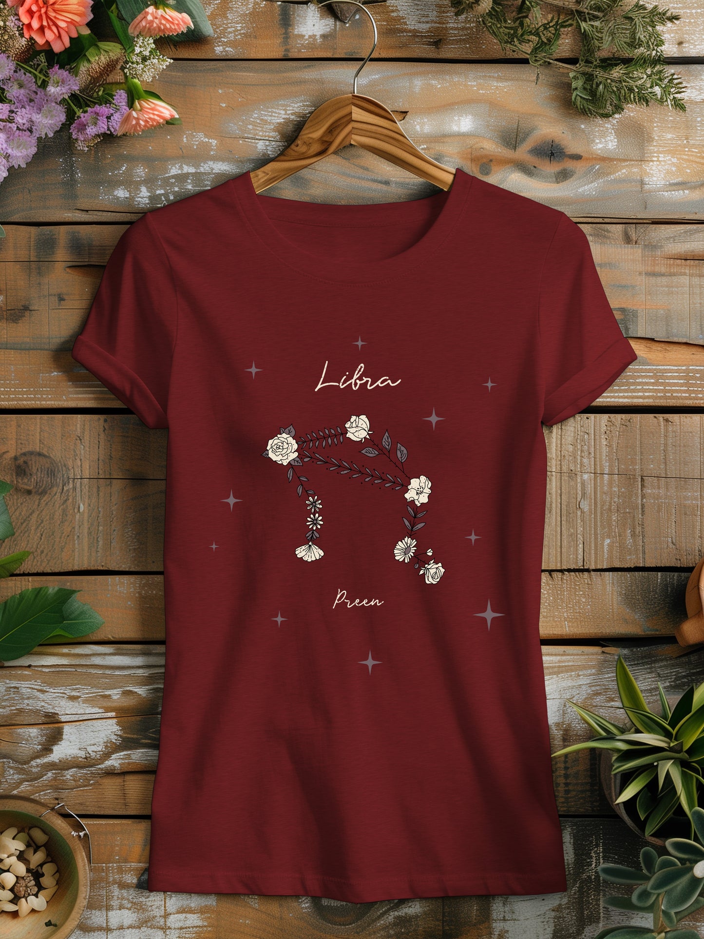 a red t - shirt with a picture of a libra zodiac on it