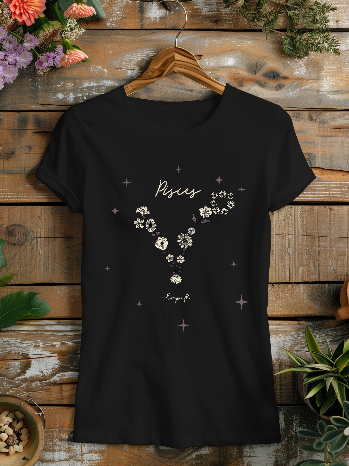 a black t - shirt with flowers and stars on it