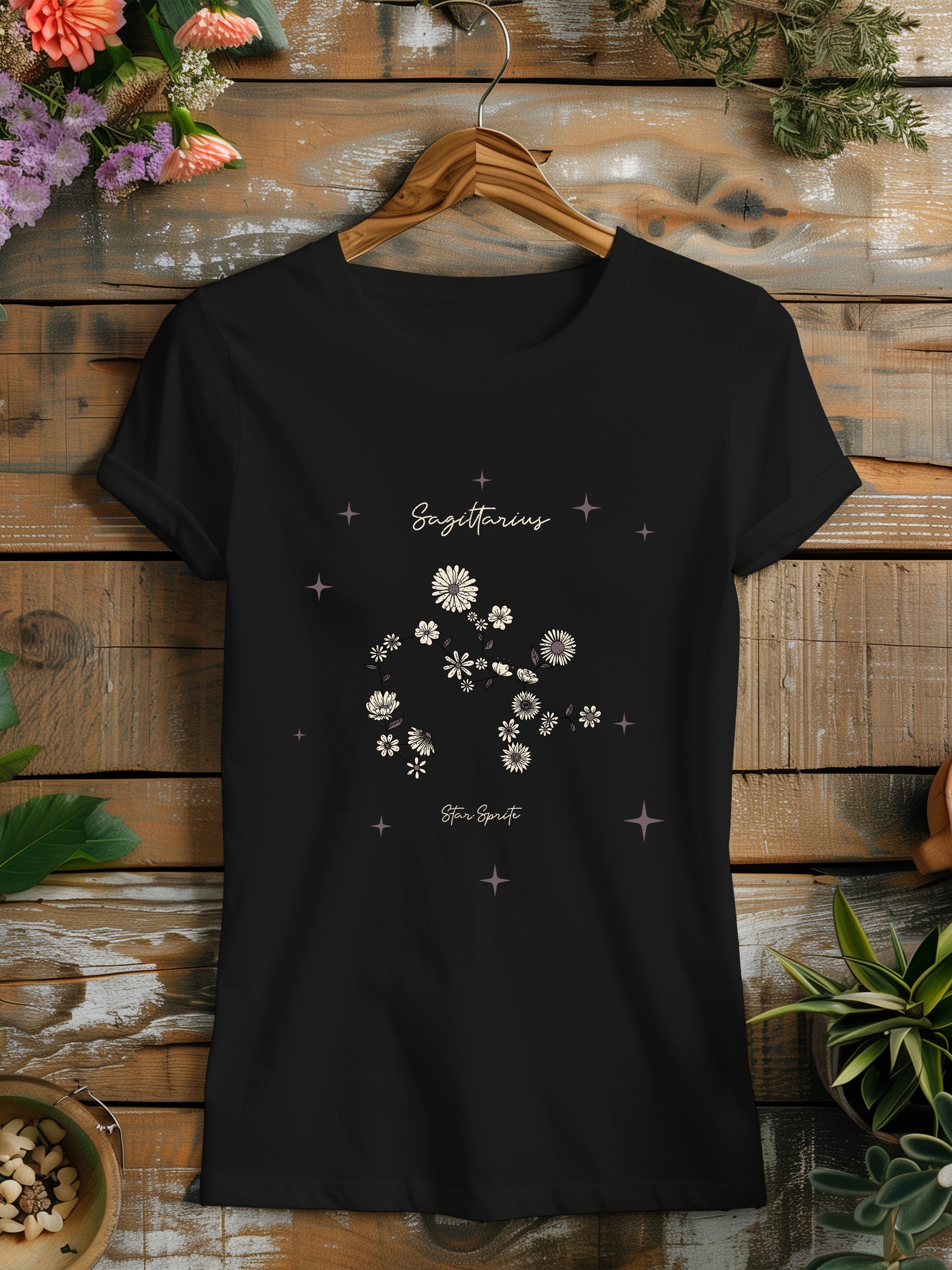 a black t - shirt with white flowers on it