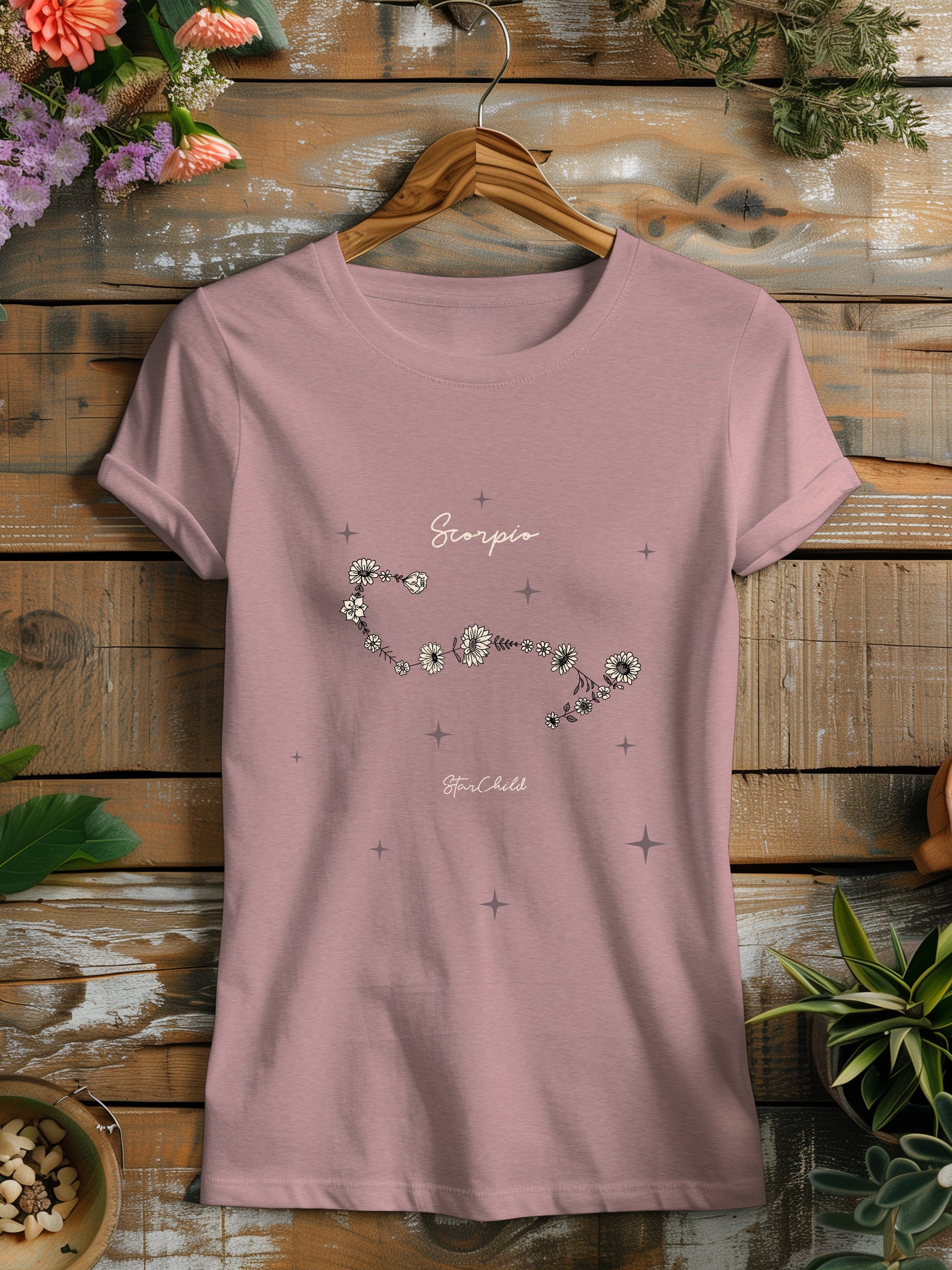 a pink t - shirt with a picture of flowers on it