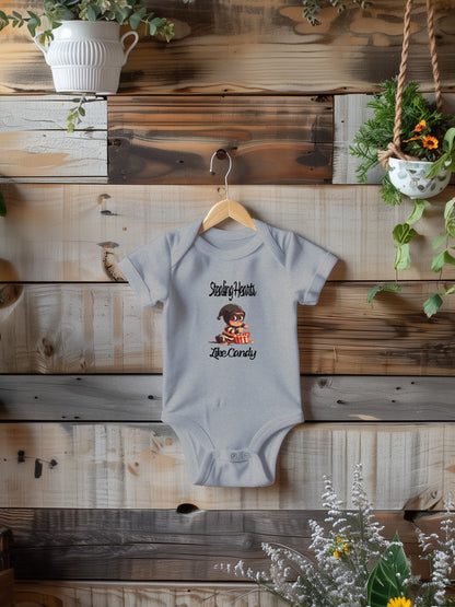 a baby bodysuit hanging on a wooden wall