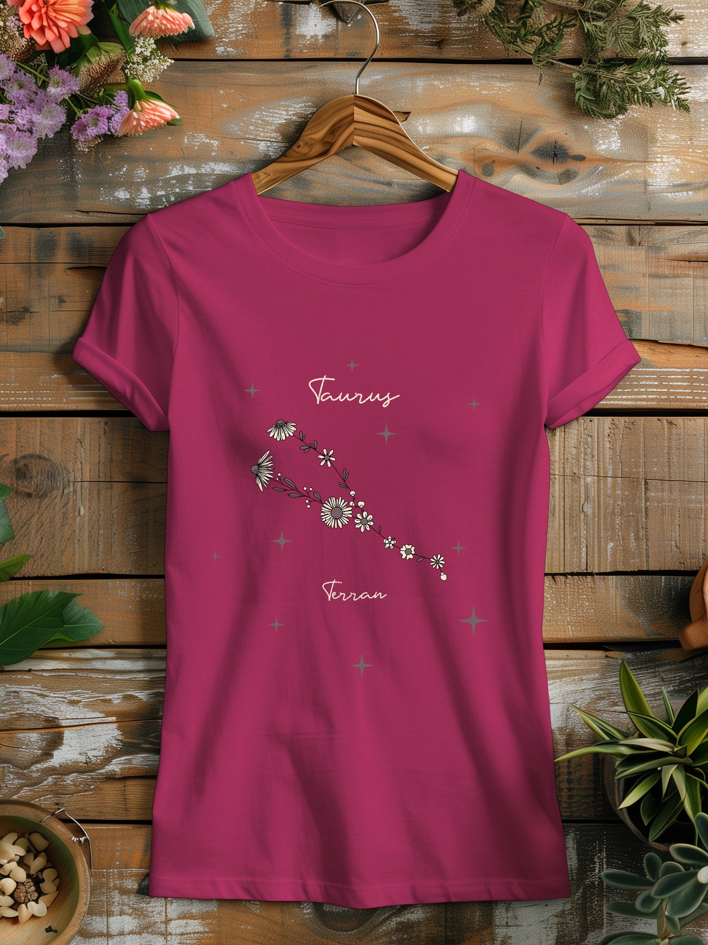 a pink t - shirt with a flower design on it