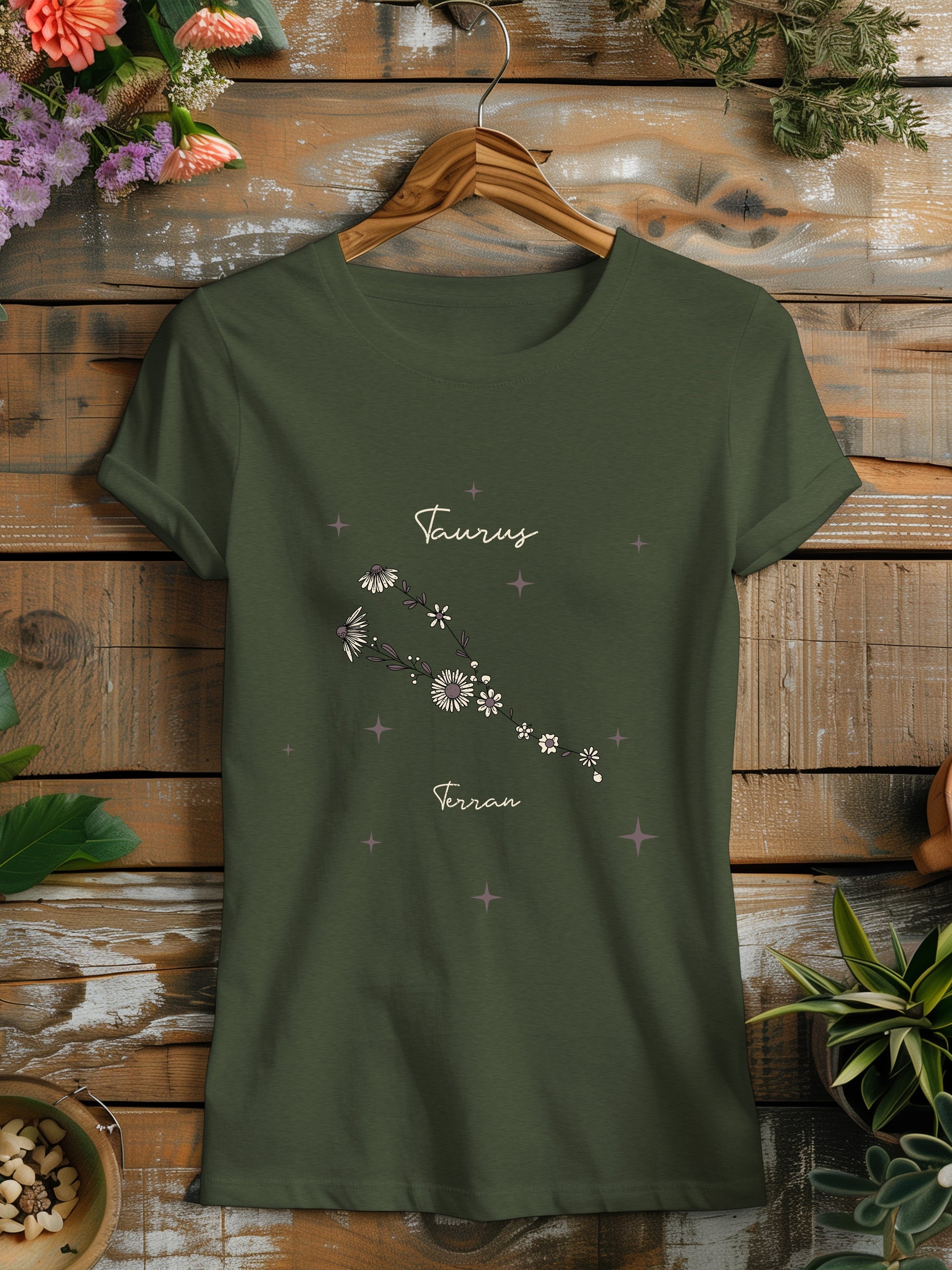 a green t - shirt with a picture of a flower on it