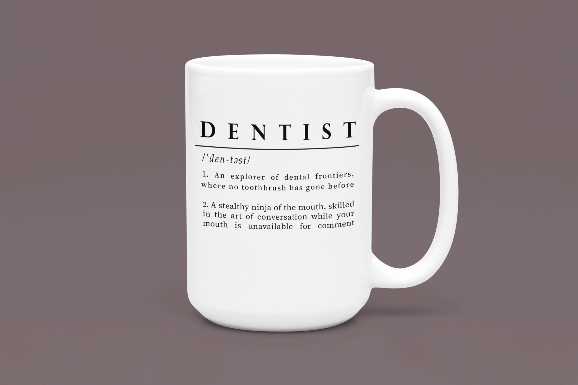 A white ceramic mug printed with black text that humorously defines 'DENTIST' as both an explorer of dental frontiers and a stealthy ninja of the mouth. 