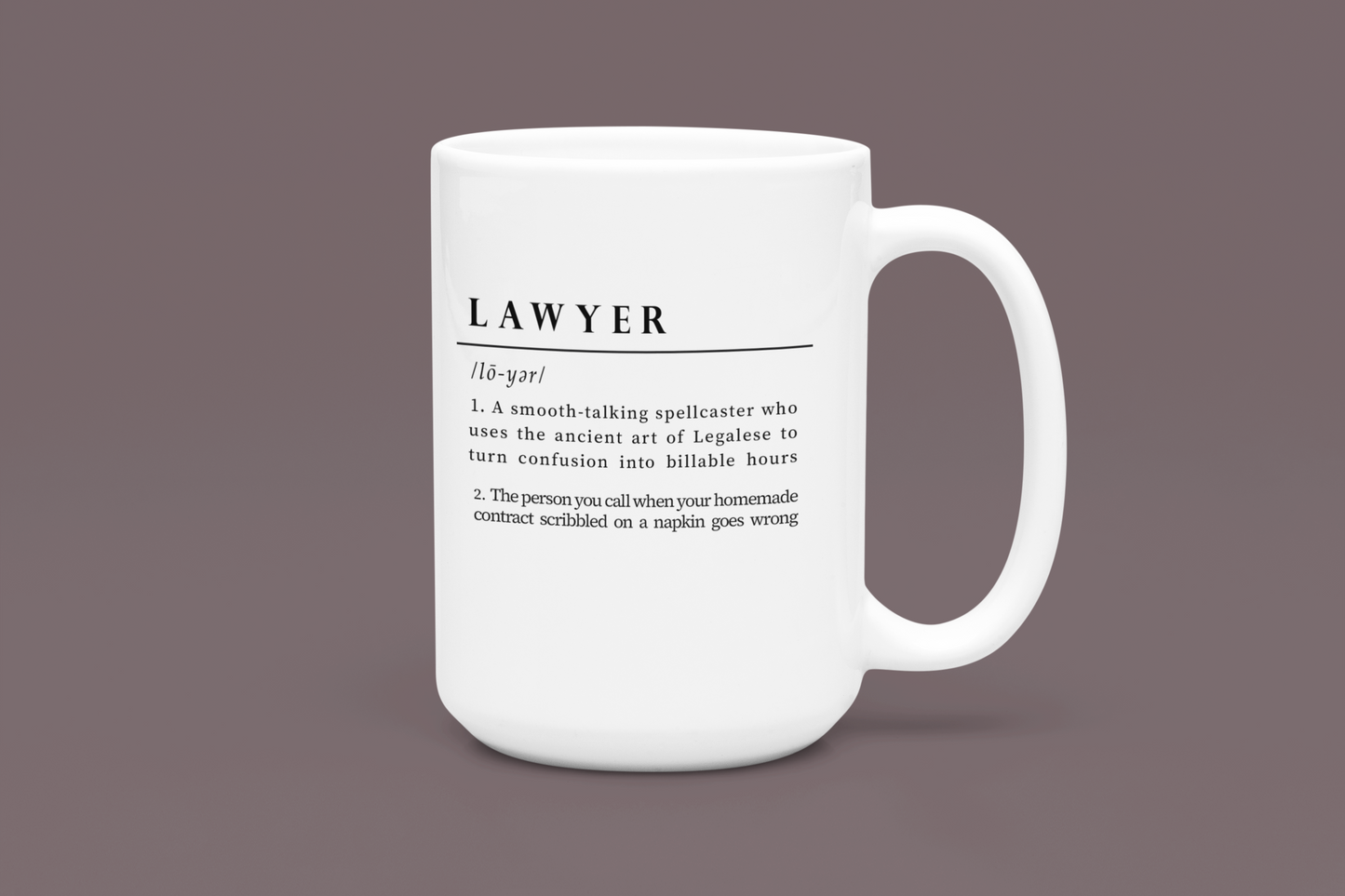 A white ceramic mug displays a playful and witty definition of 'Lawyer', printed in a bold black font. The text humorously depicts a lawyer as a spellcaster in Legalese and a savior of napkin contracts. 