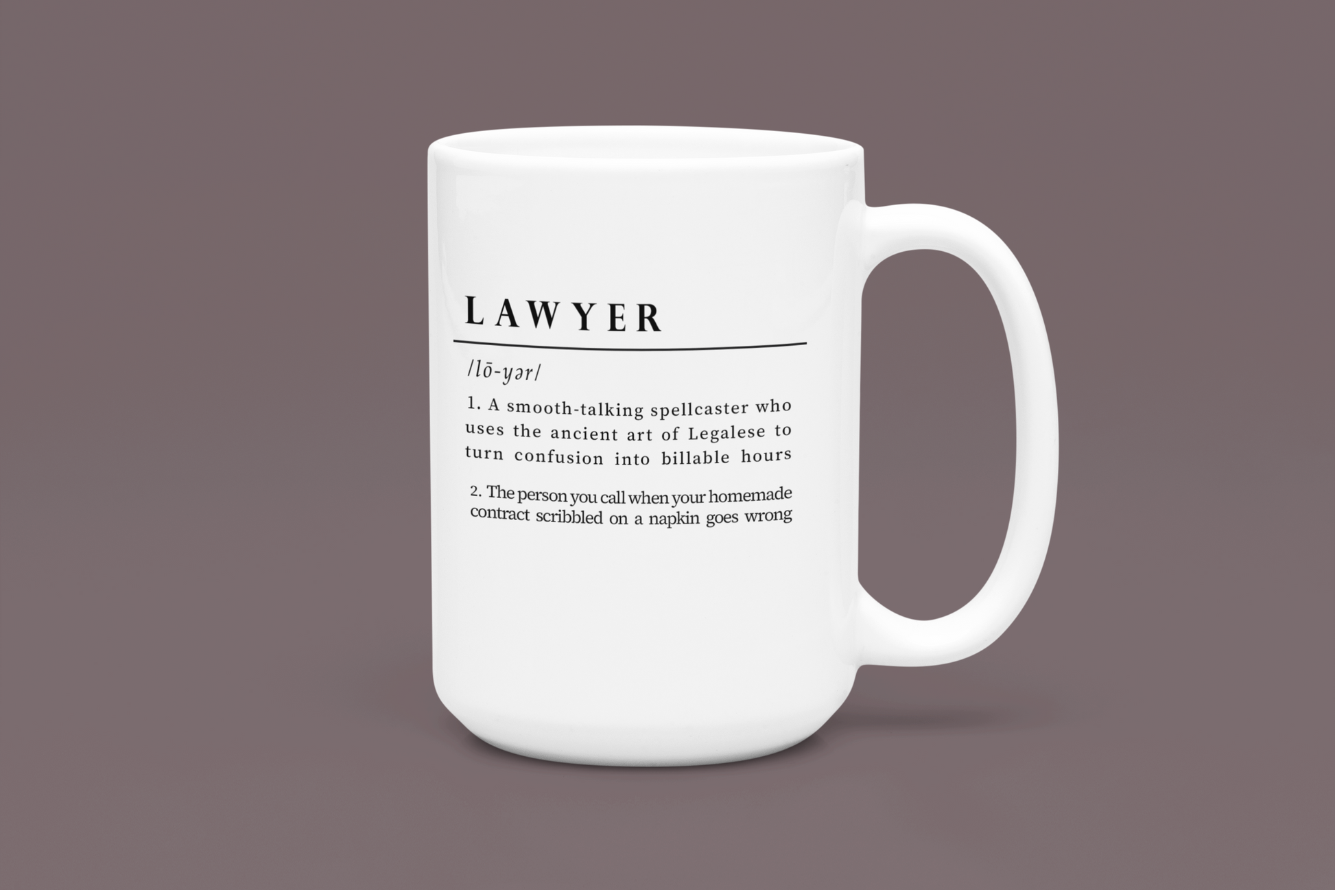 A white ceramic mug displays a playful and witty definition of 'Lawyer', printed in a bold black font. The text humorously depicts a lawyer as a spellcaster in Legalese and a savior of napkin contracts. 