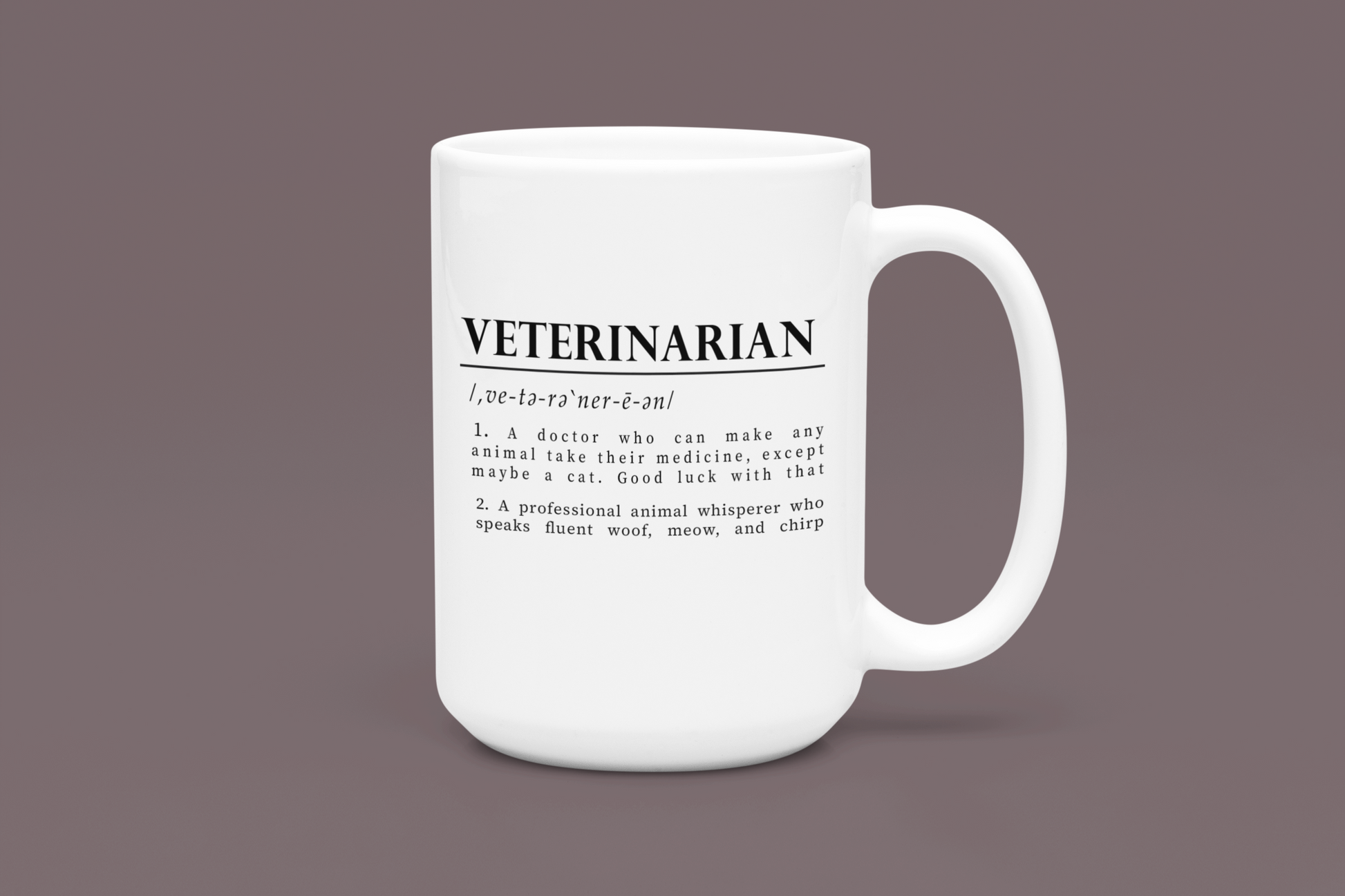 a white cup with bold black text on a plain white background defining 'Veterinarian'. The definition humorously mentions a vet's challenges with medicating animals, especially cats, and describes them as fluent in animal sounds.