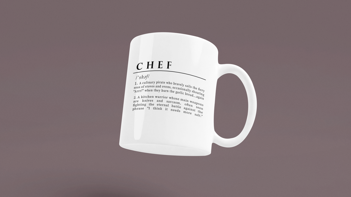 A white ceramic mug with a playful and humorous definition of 'Chef', printed in sharp black lettering. The text describes a chef as a culinary pirate and a kitchen warrior, humorously highlighting the challenges and quirks of culinary life. 