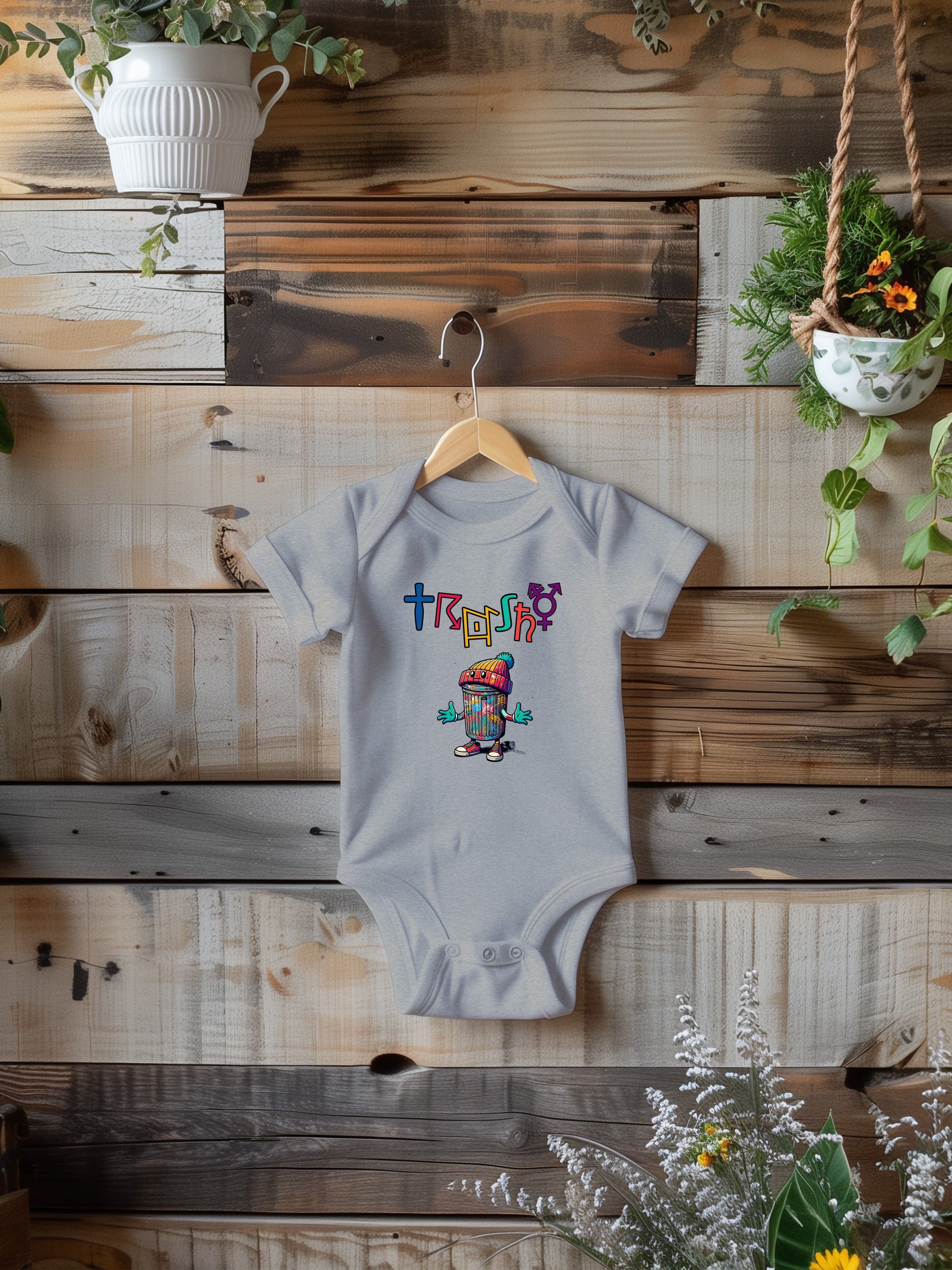 a baby one piece jumper with a picture of a hip trash can figure with the word trashy above it